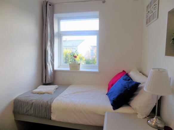 Bright, neatly presented bedroom with a comfort...