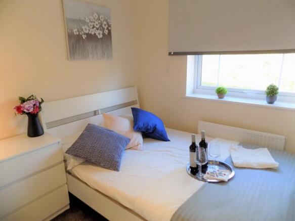 Bright, neatly presented bedroom with a modern ...