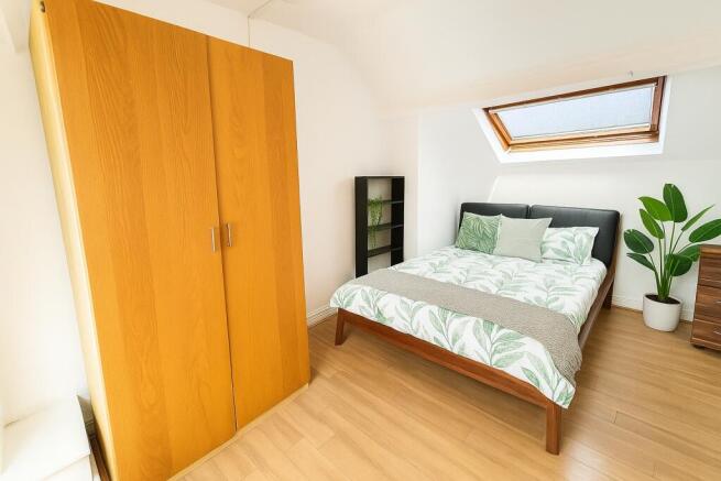 Bright and cozy double bedroom featuring a comf...