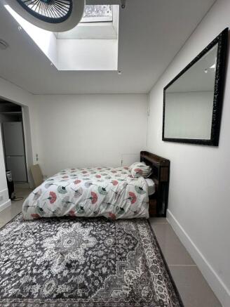 Bright, neatly presented bedroom with a comfort...
