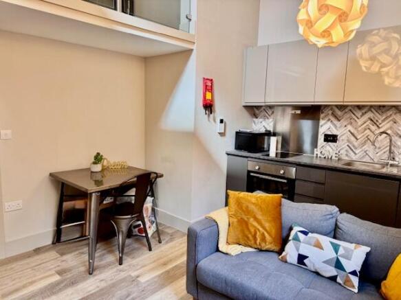 Bright, modern open-plan living area with a coz...