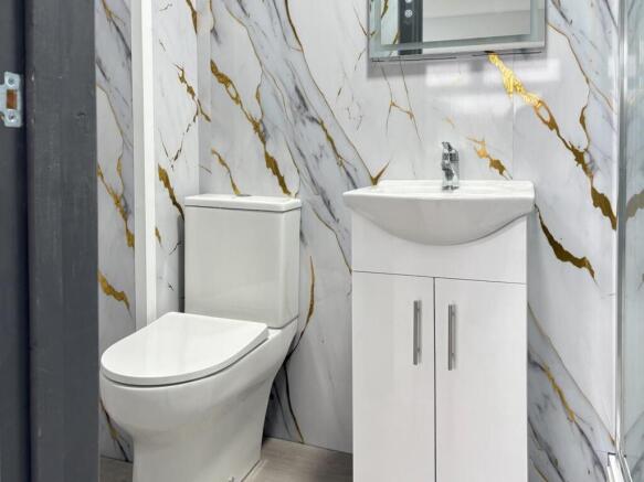 Bright, modern bathroom with a sleek white toil...