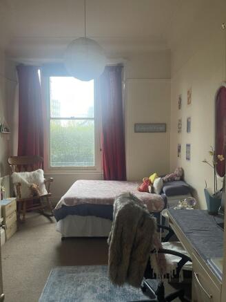 Bright, cozy bedroom with a large sash window, ...