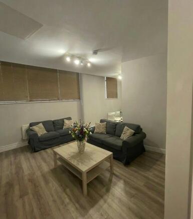 Well-presented communal lounge with two comfort...