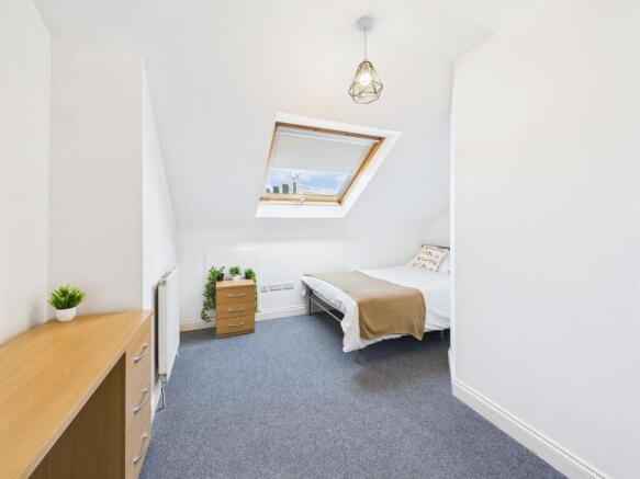 Bright, neatly presented loft bedroom with a sk...