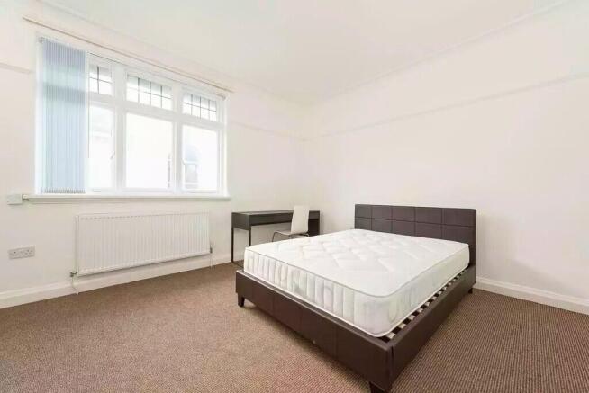 Bright, simply furnished double bedroom with a ...