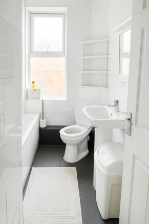 Bright, modern bathroom with clean white tiling...