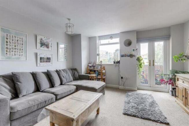 Bright and inviting living room featuring a spa...