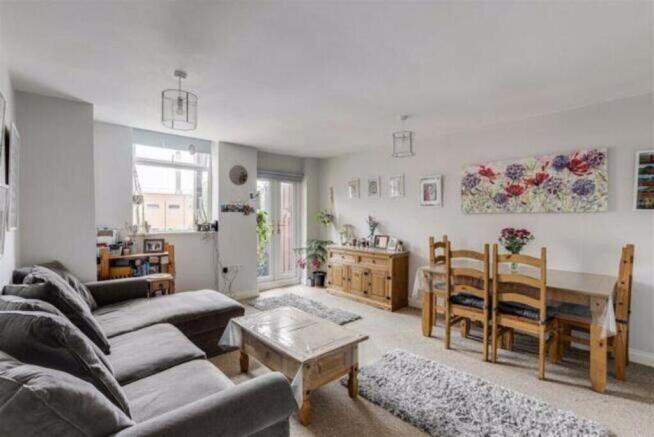 Spacious and inviting living room featuring lar...