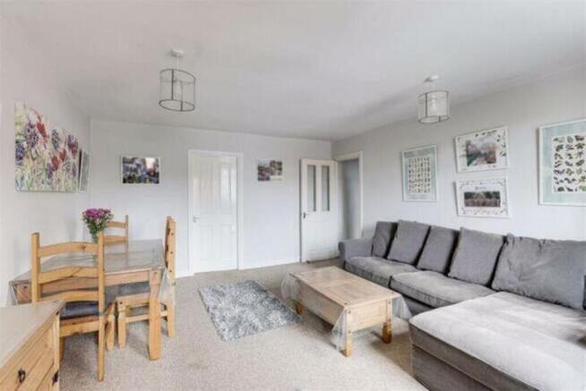 A bright and inviting living room featuring a c...
