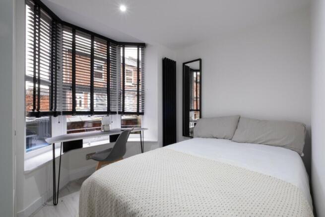 A beautifully designed double bedroom featuring...