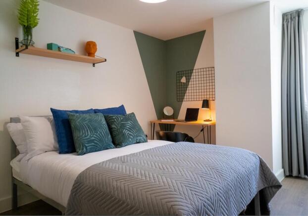 A stylish and well-lit double bedroom with mode...