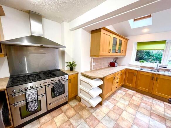Spacious and well-equipped kitchen featuring am...