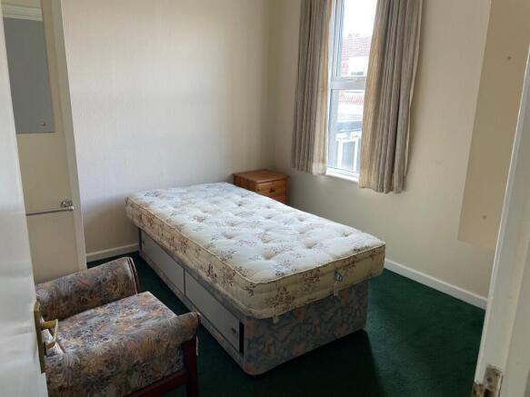 This cozy double bedroom features a comfortable...