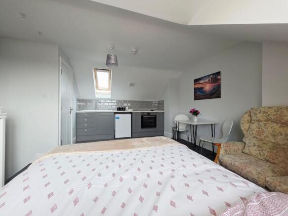 Bright and inviting living area featuring a bed...