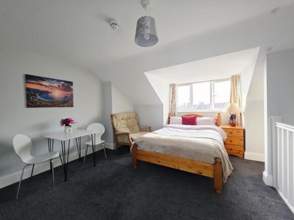 Bright and spacious master bedroom featuring a ...