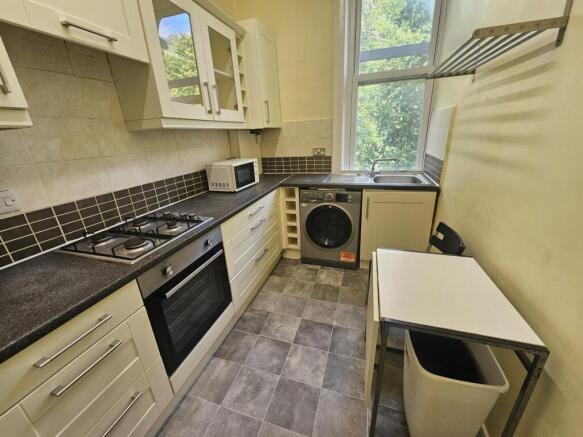 A well-lit, modern kitchen featuring spacious c...