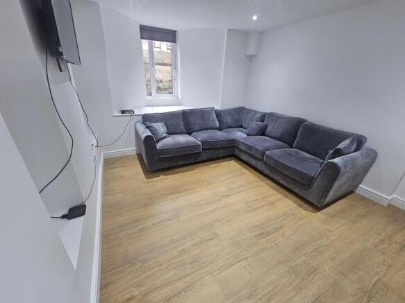 A bright and spacious living room featuring a c...