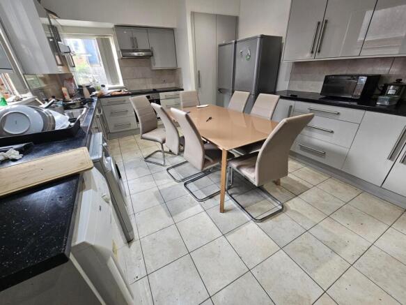 A clean and well-lit modern kitchen with white ...