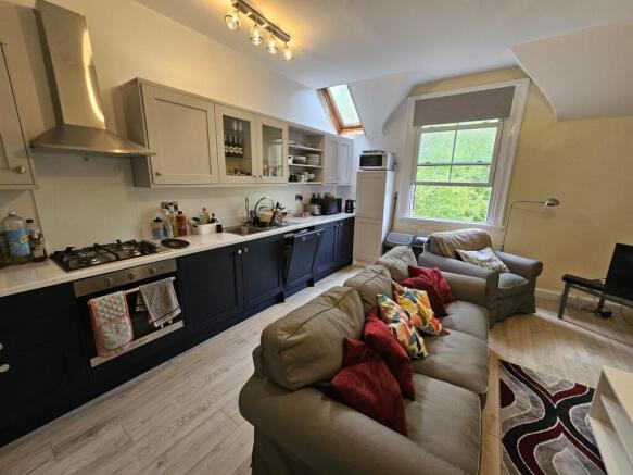 A spacious and well-lit contemporary living roo...