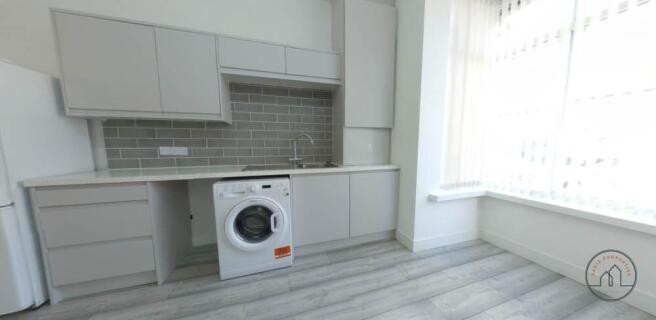 Bright modern kitchen with light wood-effect fl...