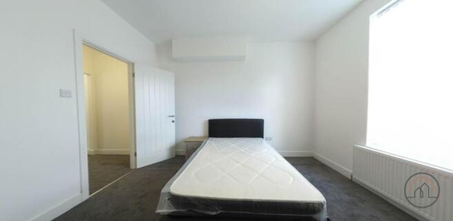 Bright, neutrally decorated bedroom with a doub...