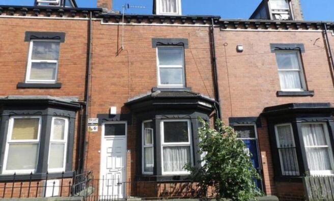 Well-maintained terraced brick house with a bay...