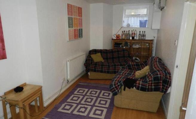 Cozy living room with two sofas, patterned rugs...