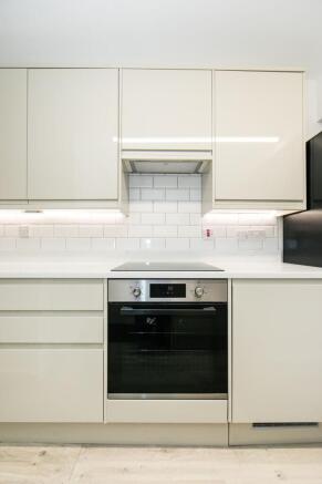 Bright modern kitchen with integrated oven, cle...