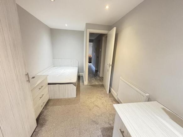 Neat, neutral single bedroom with fitted storag...