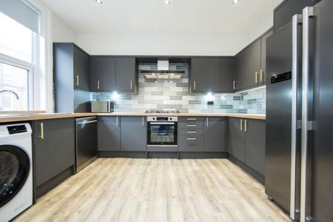 Contemporary fitted kitchen with sleek grey cab...