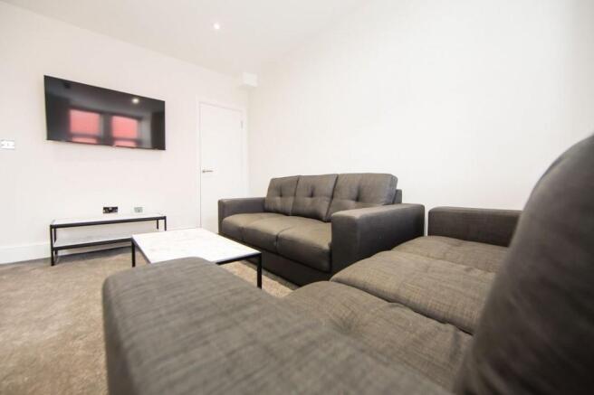 Bright, neutral living room with two comfortabl...