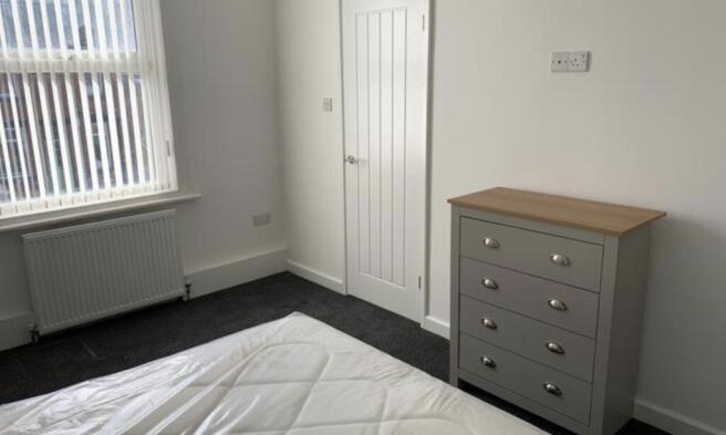 Bright, neat bedroom with a double bed, fitted ...
