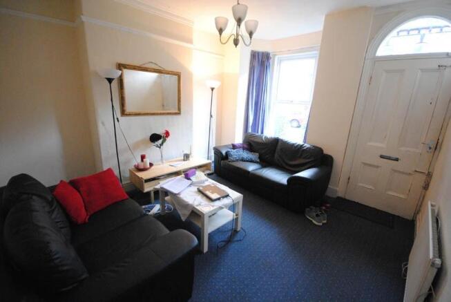 Bright, neatly presented living room with two c...