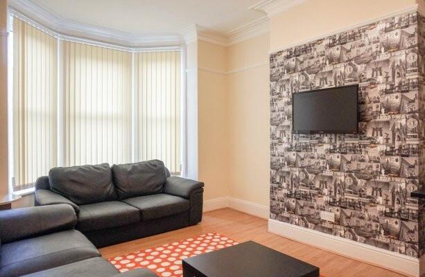 Bright, well-presented living room with a large...