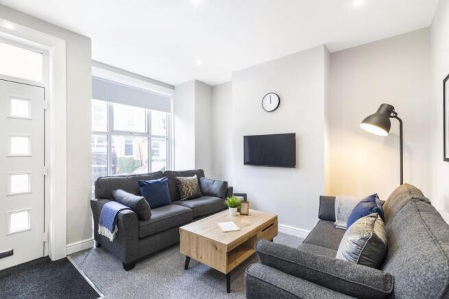 Bright, contemporary living room with two comfo...