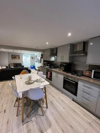 Modern open-plan kitchen and living area with s...