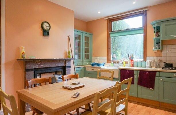 Warm, well-equipped kitchen with painted cabine...