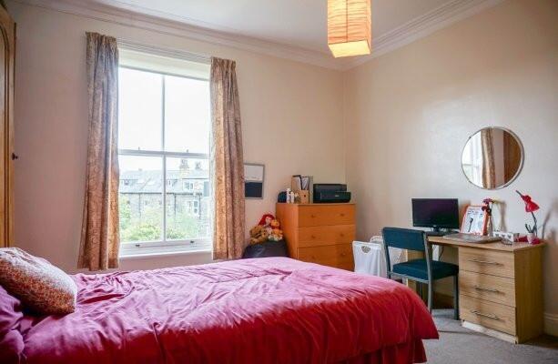 Bright, cosy bedroom with a large window, comfo...