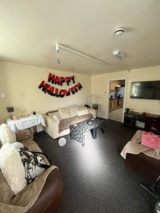 Bright communal living room with comfortable so...