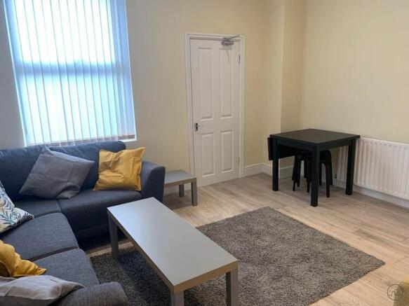 Bright, well-kept living room with a comfortabl...