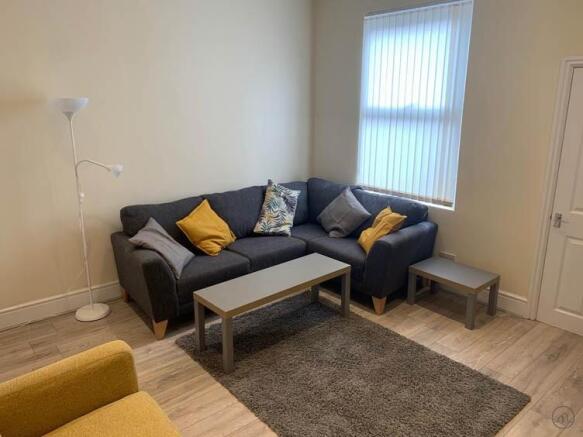 Bright, modern living area with a comfy L-shape...