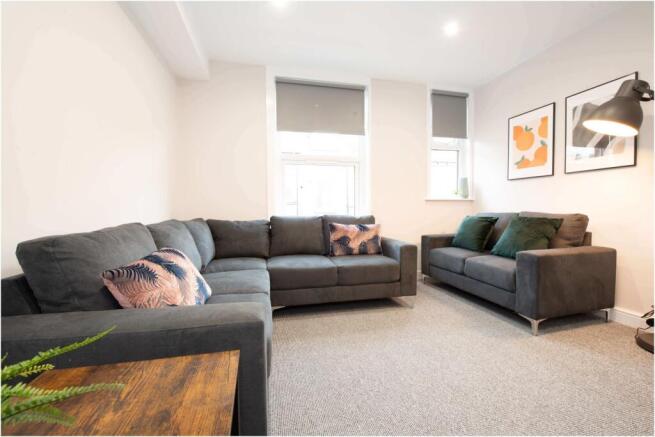 Bright, modern living room with two comfortable...