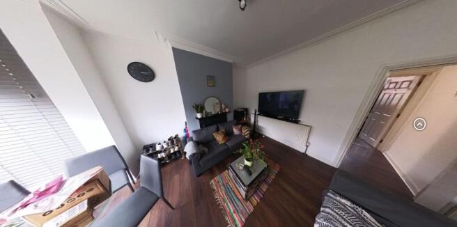 Bright, contemporary living room with wood-effe...