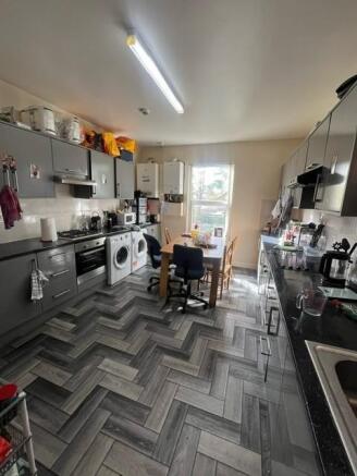 Bright, modern shared kitchen with grey fitted ...