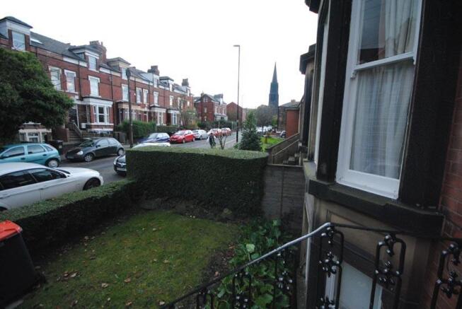 Street view of a residential terrace with a sma...