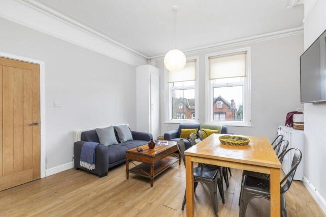 Bright, modern living space with wood flooring,...