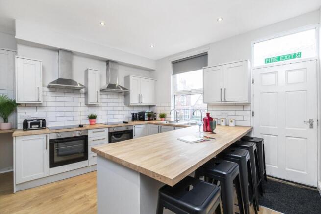 Bright modern kitchen with a central breakfast ...