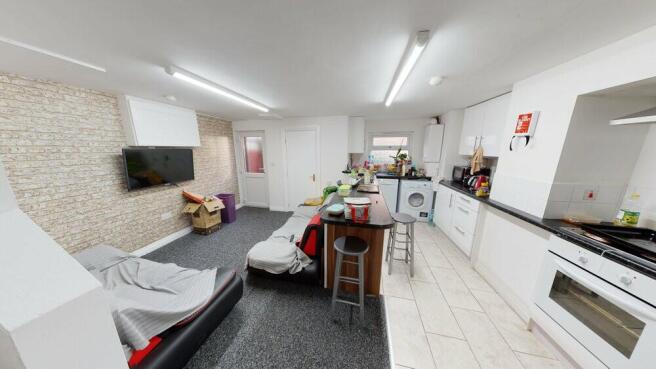 Open-plan living area with a modern fitted kitc...