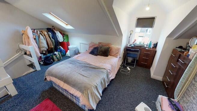 Bright attic double bedroom with a double bed p...